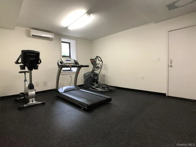 a room with gym equipment and a large window