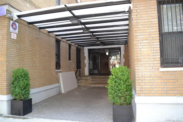 a view of a house with potted plants