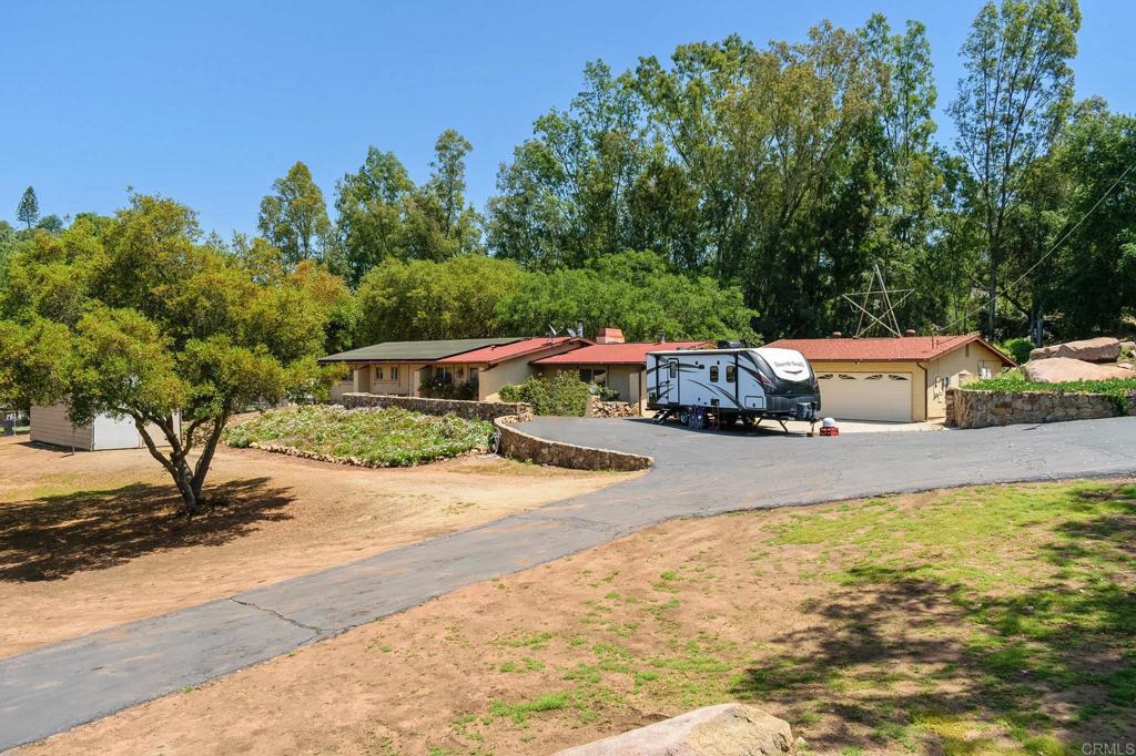 a view of a house with swimming pool and sitting area