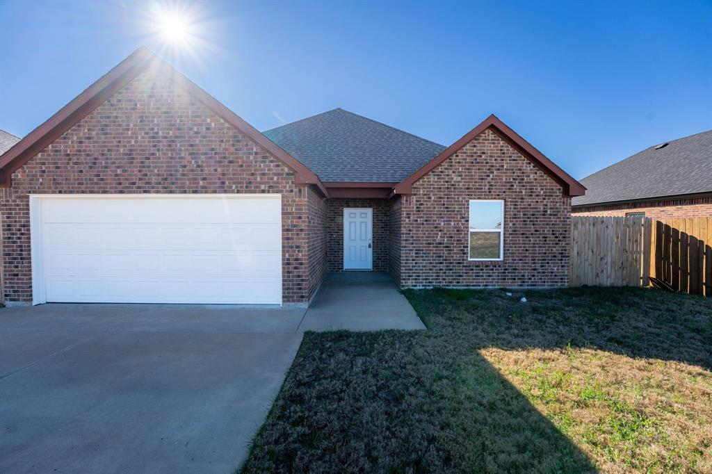 1020 Springview Lane Mabank, TX 75147 - Photo 2 of 15 Ranch-style house featuring an attached garage, brick siding, a shingled roof, and driveway