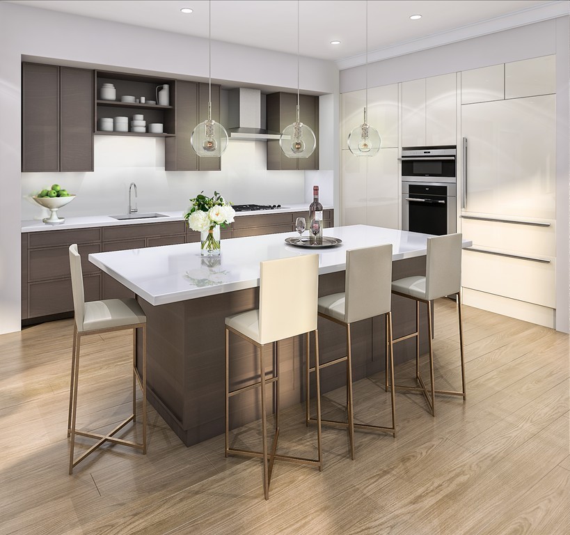 158 Winthrop Road, Unit 1 Brookline, MA 02445 - Photo 3 of 5 a kitchen with stainless steel appliances kitchen island granite countertop a table chairs and a refrigerator