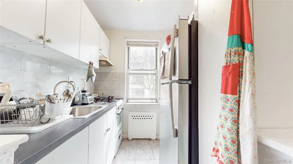 a kitchen with a refrigerator and a sink