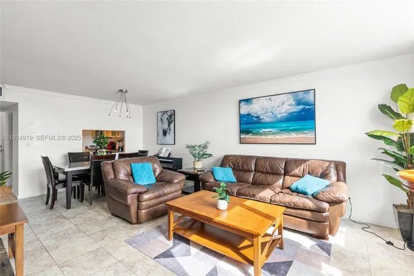a living room with furniture a rug and a lamp