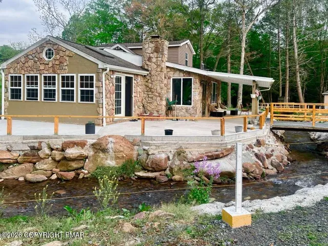 a front view of a house with yard porch and seating area