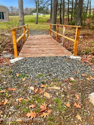 a view of a pathway with a wrought fence