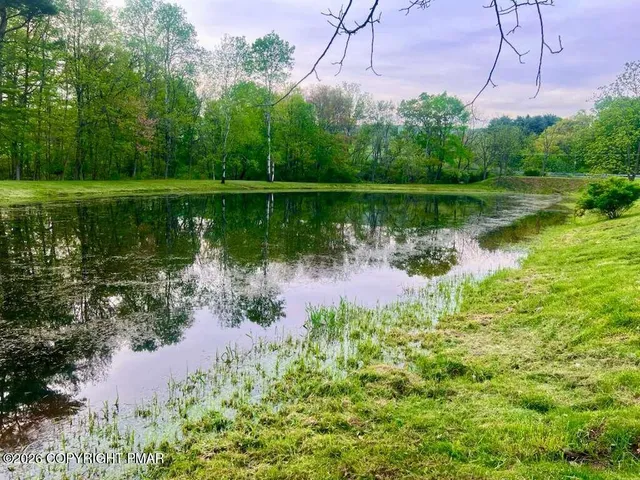 a view of a lake with a house in the background