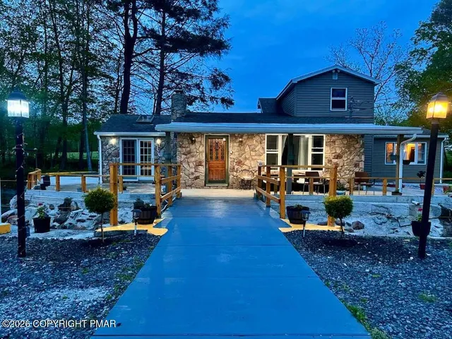 a view of a house with backyard porch and sitting area
