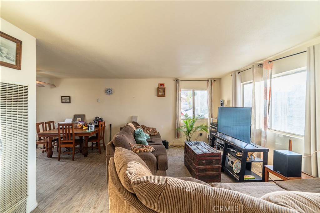 61464 Desert Air Road Joshua Tree, CA 92252 - Photo 2 of 12 a living room with furniture and wooden floor