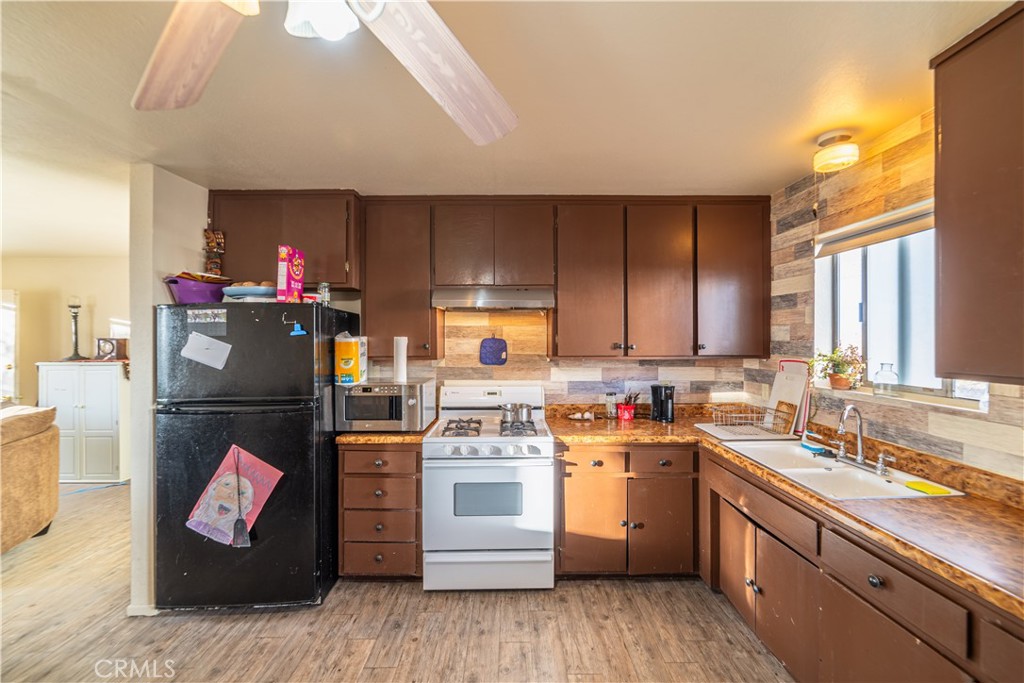 61464 Desert Air Road Joshua Tree, CA 92252 - Photo 5 of 12 a kitchen with a sink cabinets and wooden floor