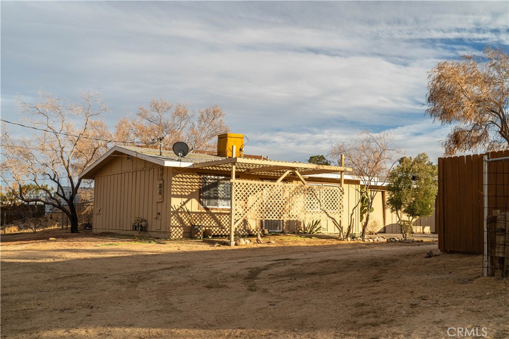 61464 Desert Air Road Joshua Tree, CA 92252 - Photo 9 of 12 a view of a house with snow on the road