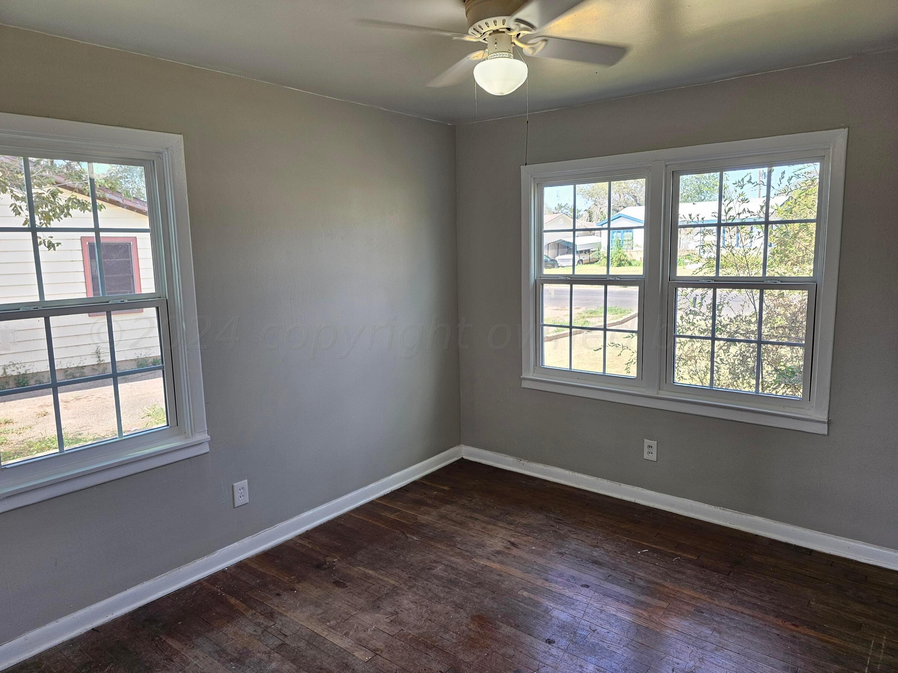 4907 Parker Street Amarillo, TX 79110 - Photo 8 of 13 an empty room with a window