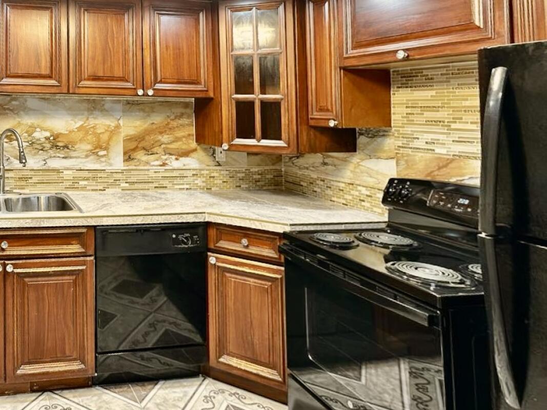 610 Northwest 13th Street, Unit 23 Boca Raton, FL 33486 - Photo 11 of 28 a kitchen with granite countertop a stove and a sink