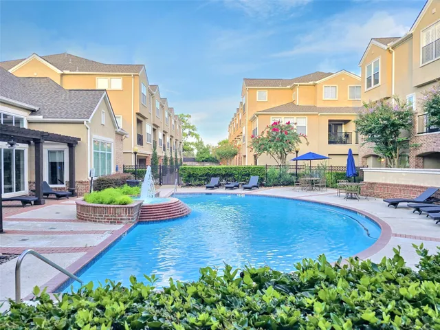 a view of a house with swimming pool and sitting area