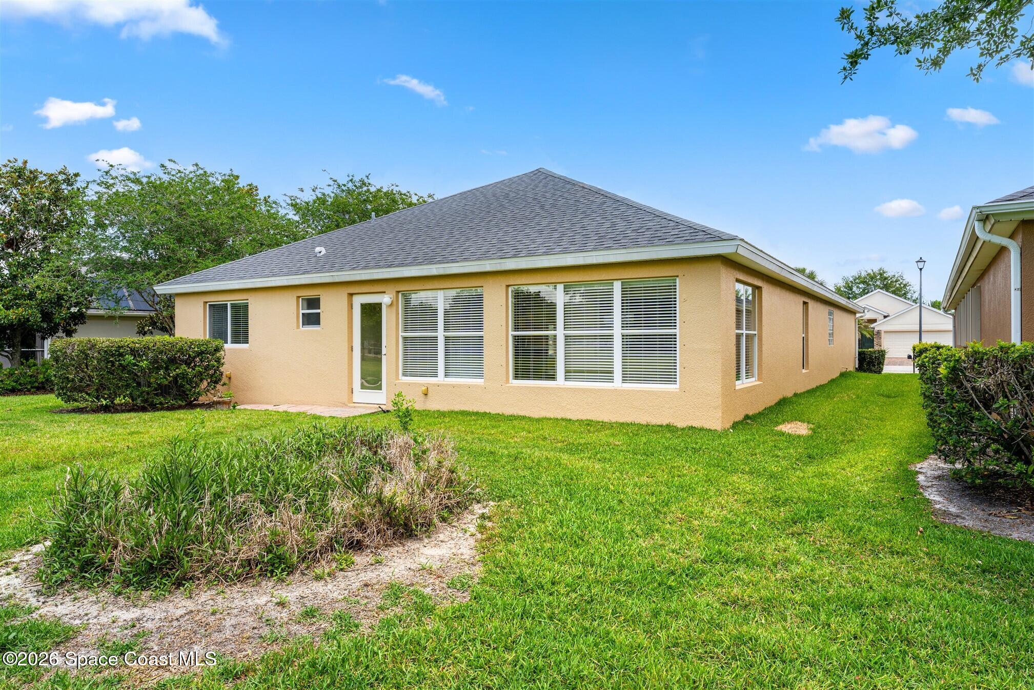 6904 Renshaw Drive Melbourne, FL 32940 - Photo 32 of 46 a view of a house with a yard