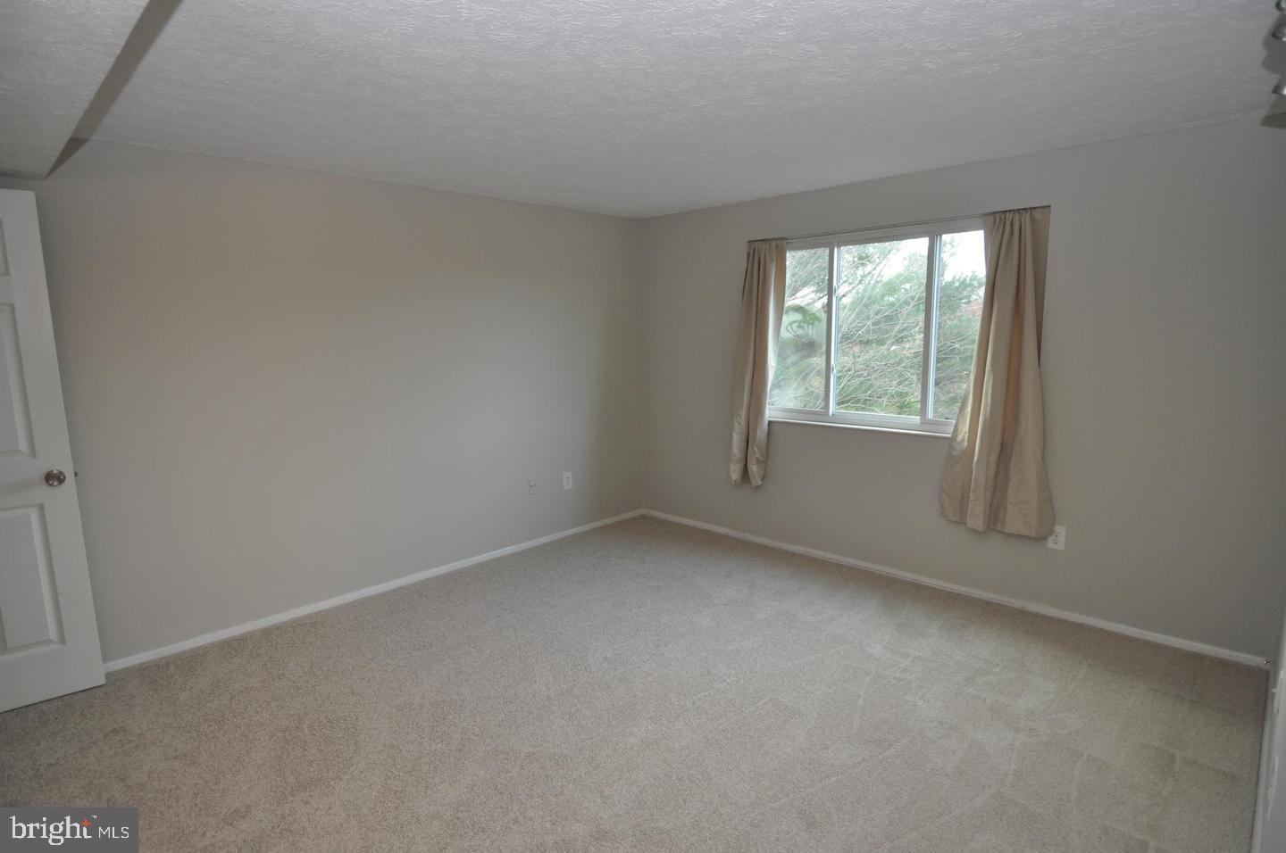 19609 Gunners Branch Road, Unit F Germantown, MD 20876 - Photo 11 of 18 an empty room with a window