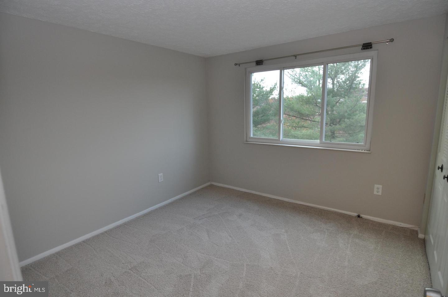 19609 Gunners Branch Road, Unit F Germantown, MD 20876 - Photo 12 of 18 an empty room with a window