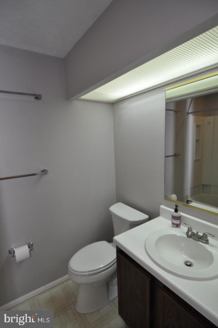 19609 Gunners Branch Road, Unit F Germantown, MD 20876 - Photo 17 of 18 a bathroom with a sink a toilet and mirror
