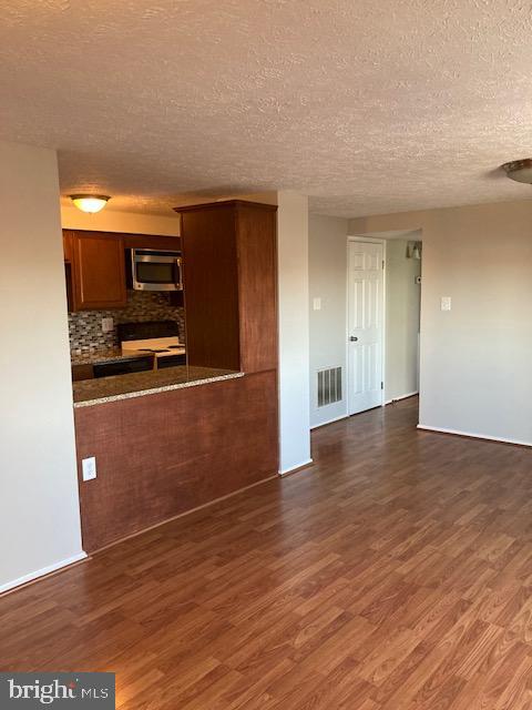 19609 Gunners Branch Road, Unit F Germantown, MD 20876 - Photo 4 of 18 a view of a kitchen with wooden floor and electronic appliances