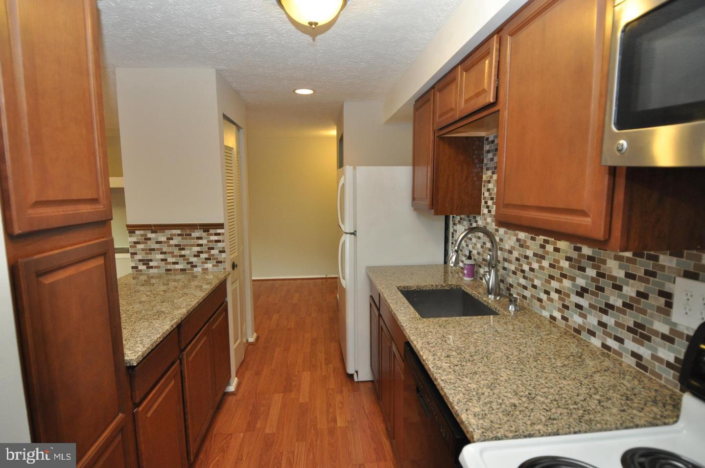 19609 Gunners Branch Road, Unit F Germantown, MD 20876 - Photo 5 of 18 a bathroom with a granite countertop sink and a mirror