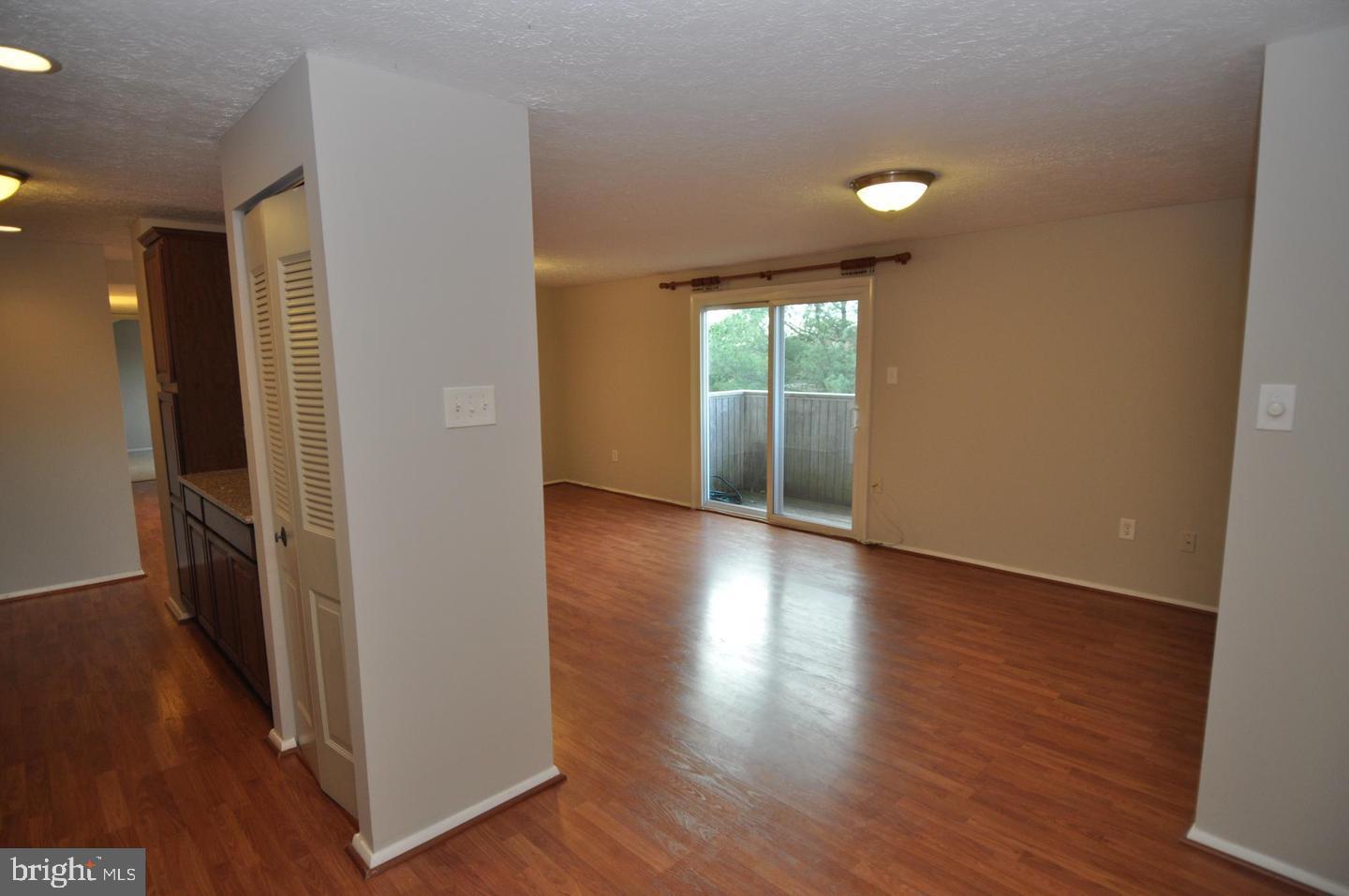 19609 Gunners Branch Road, Unit F Germantown, MD 20876 - Photo 7 of 18 wooden floor in an empty room with a window