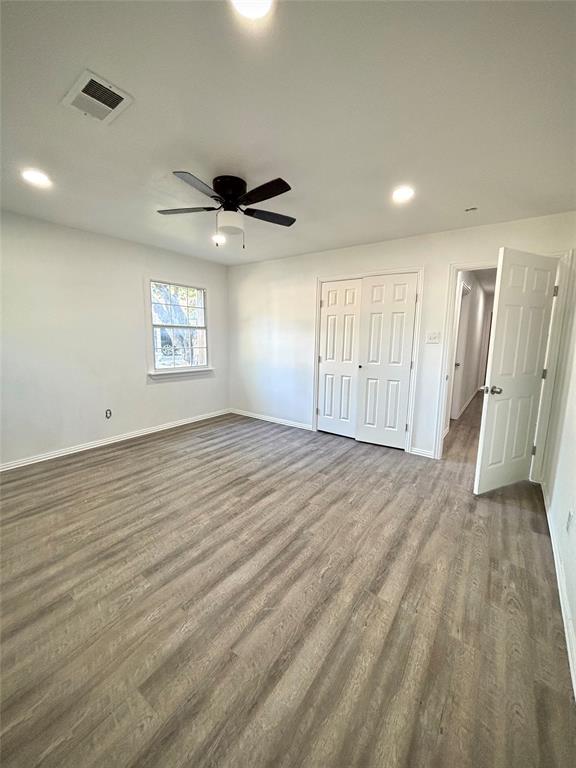 3557 Reeves Street North Richland Hills, TX 76117 - Photo 15 of 34 an empty room with wooden floor and windows