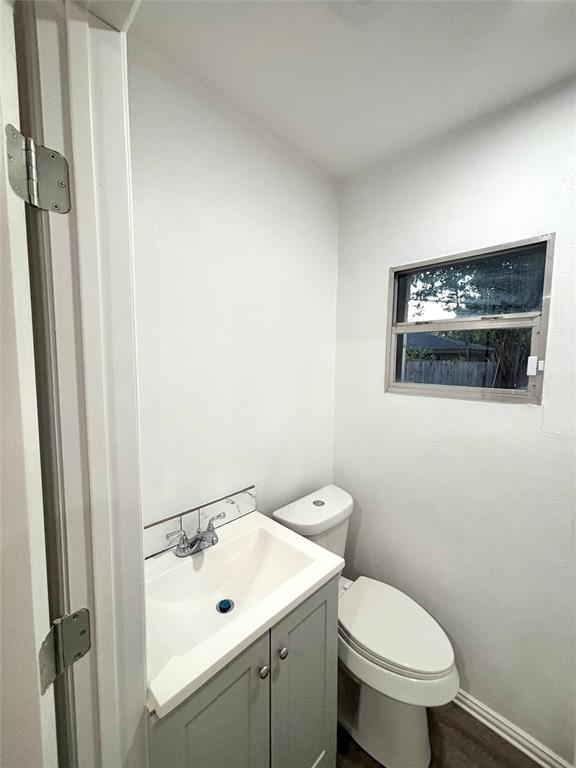 3557 Reeves Street North Richland Hills, TX 76117 - Photo 22 of 34 a bathroom with a toilet a sink and mirror
