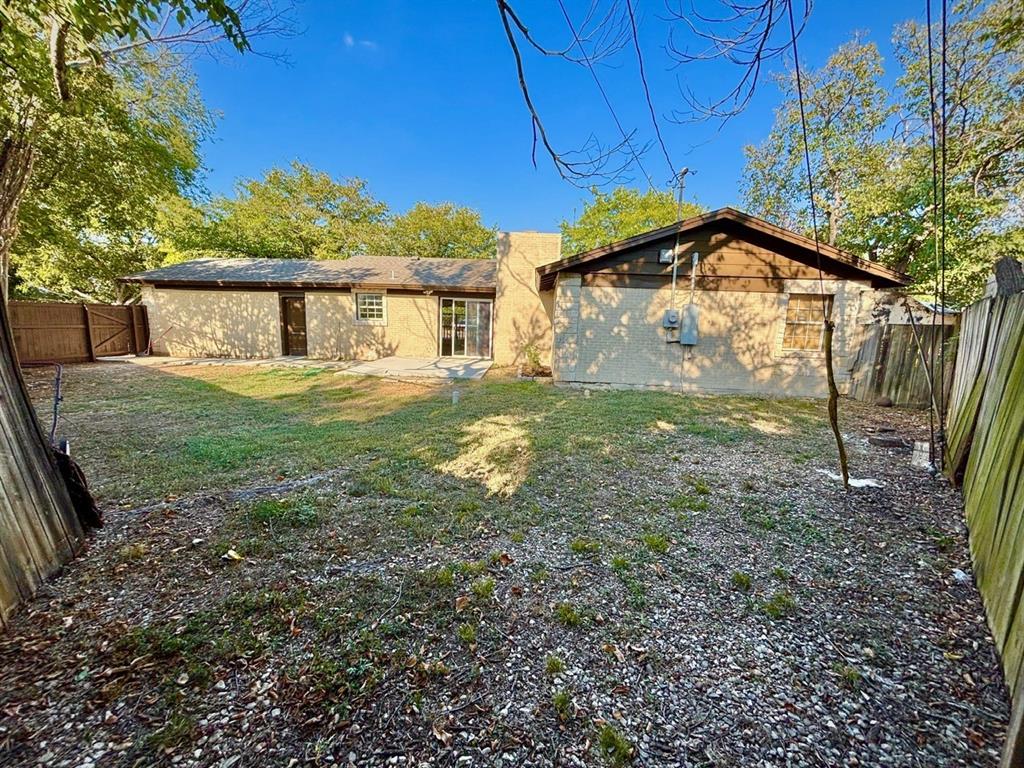 3557 Reeves Street North Richland Hills, TX 76117 - Photo 26 of 34 a yellow house sitting in middle of the forest