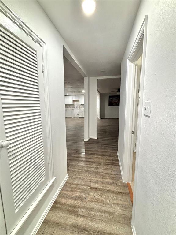 3557 Reeves Street North Richland Hills, TX 76117 - Photo 29 of 34 a view of a hallway with wooden floor and staircase