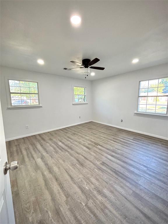 3557 Reeves Street North Richland Hills, TX 76117 - Photo 32 of 34 an empty room with windows and ceiling fan