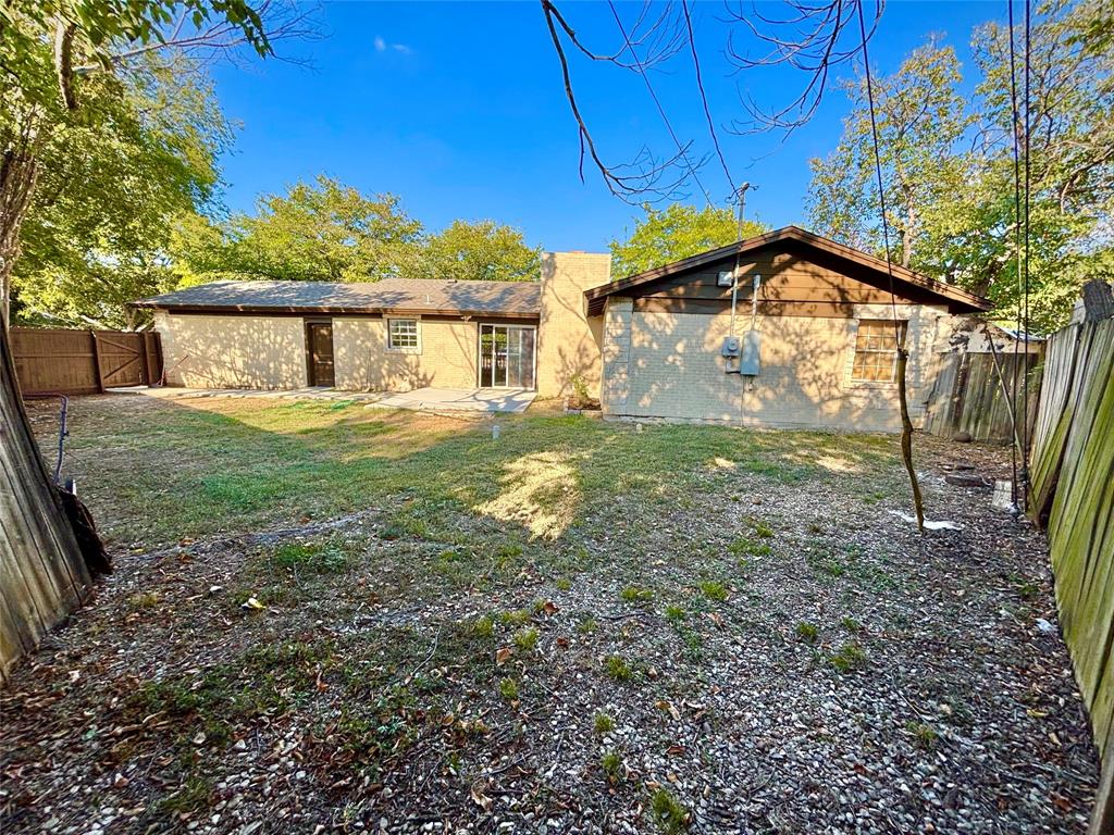 3557 Reeves Street North Richland Hills, TX 76117 - Photo 33 of 34 a yellow house sitting in middle of the forest