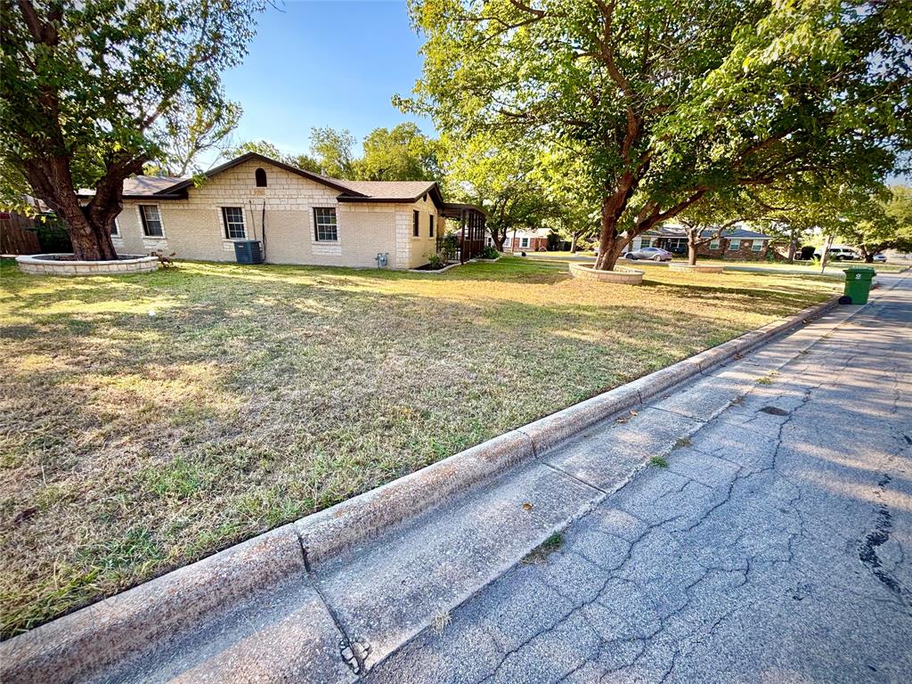 3557 Reeves Street North Richland Hills, TX 76117 - Photo 7 of 34 a view of a house with a yard