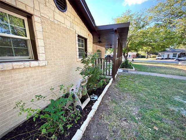 a view of a house with a yard and a garden