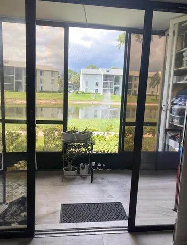 a living room with furniture and a floor to ceiling window