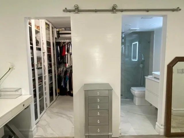 a bathroom with a granite countertop sink a toilet and a shower