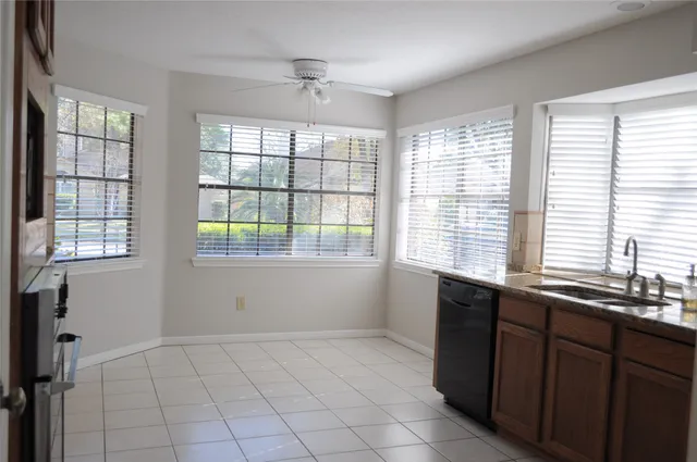 a kitchen with stainless steel appliances granite countertop a sink and a window