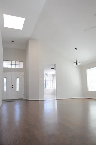 a view of empty room with wooden floor and fireplace