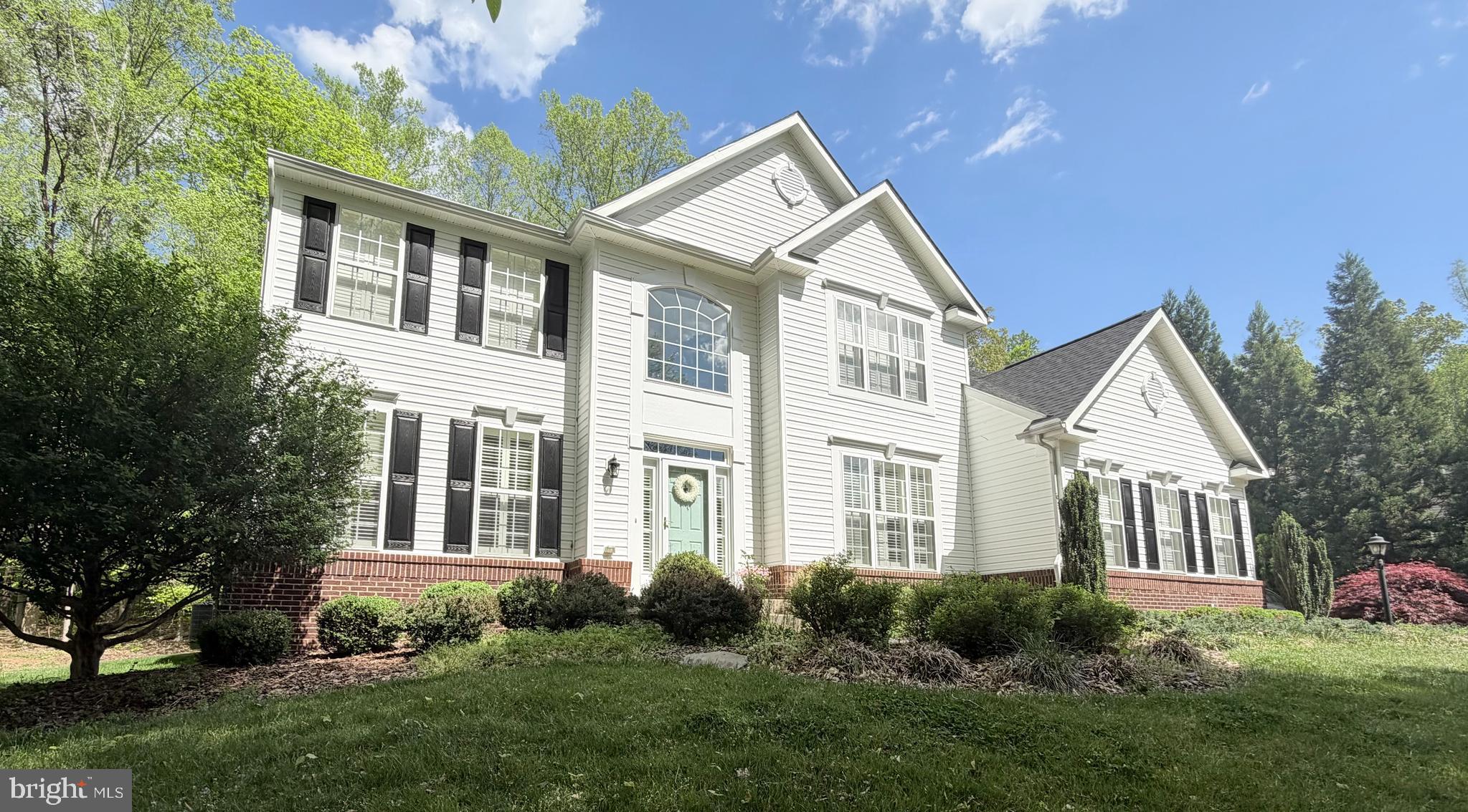 10108 Willow Ridge Lane Spotsylvania, VA 22553 - Photo 2 of 61 a front view of a house with a yard and trees