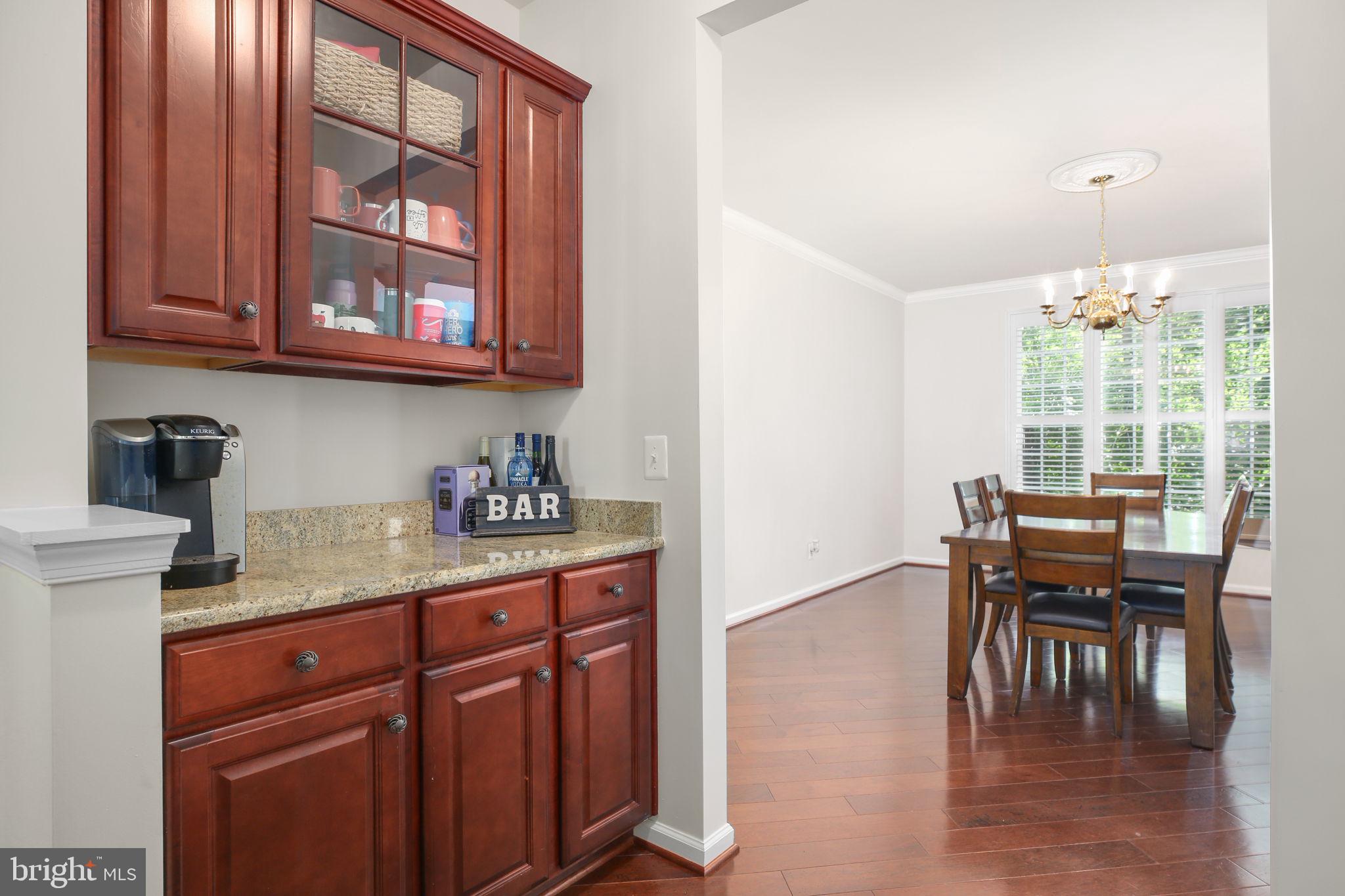 10108 Willow Ridge Lane Spotsylvania, VA 22553 - Photo 22 of 61 a kitchen with granite countertop a dining table chairs and a window