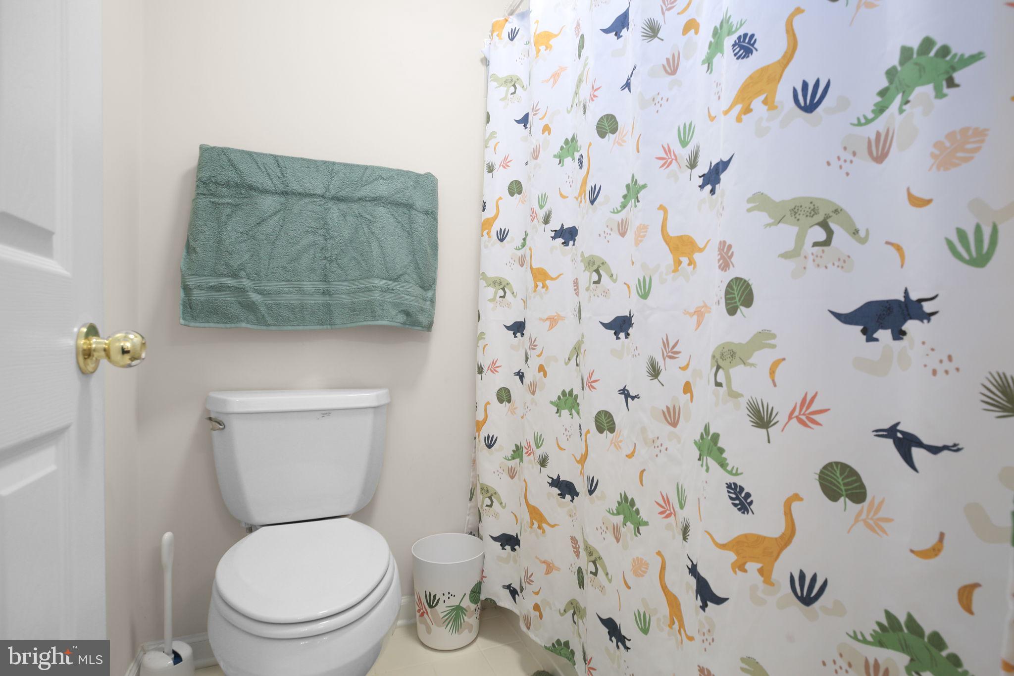 10108 Willow Ridge Lane Spotsylvania, VA 22553 - Photo 40 of 61 a white toilet sitting next to a shower curtain