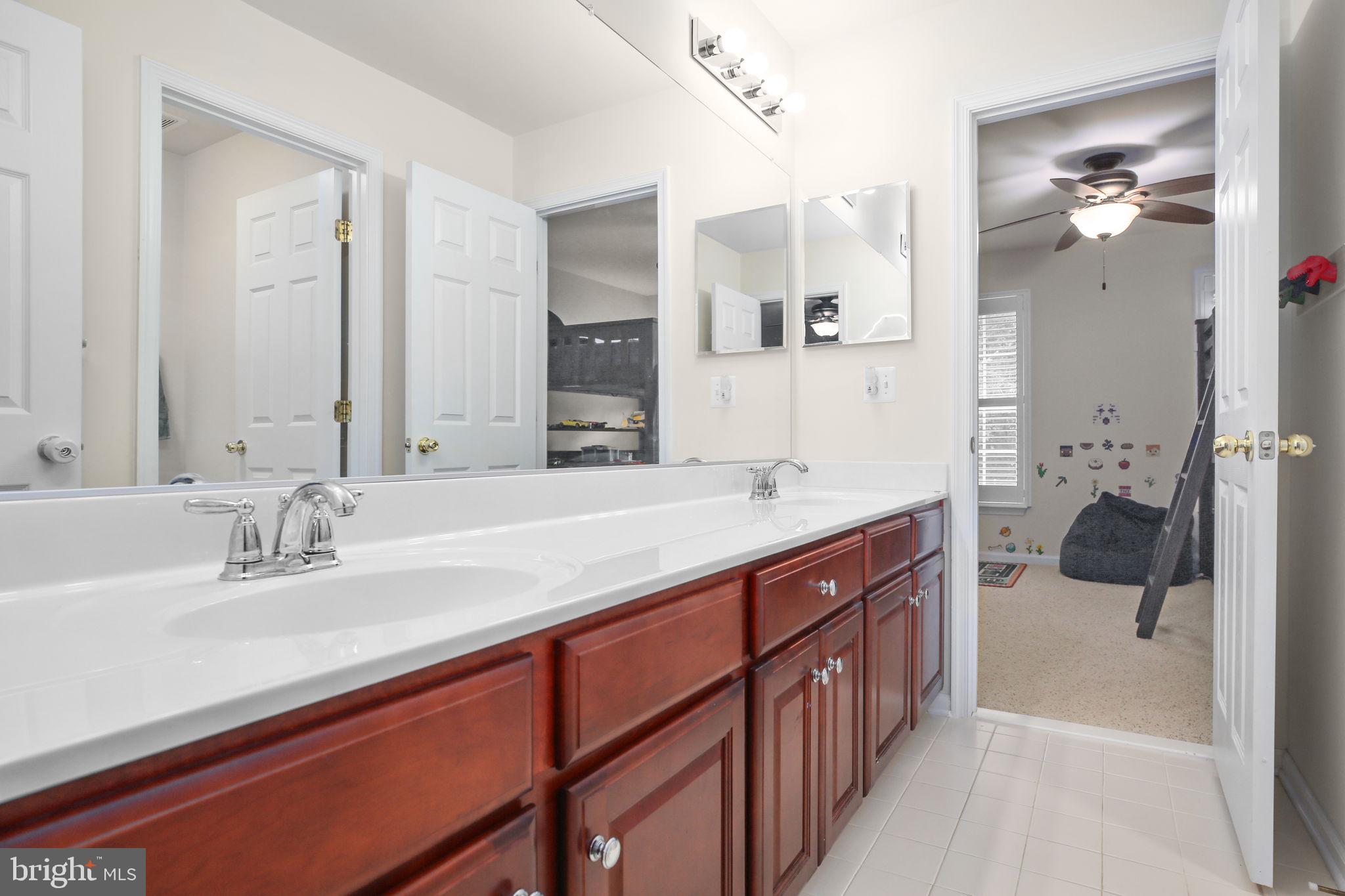 10108 Willow Ridge Lane Spotsylvania, VA 22553 - Photo 41 of 61 a spacious bathroom with a sink double vanity and a mirror