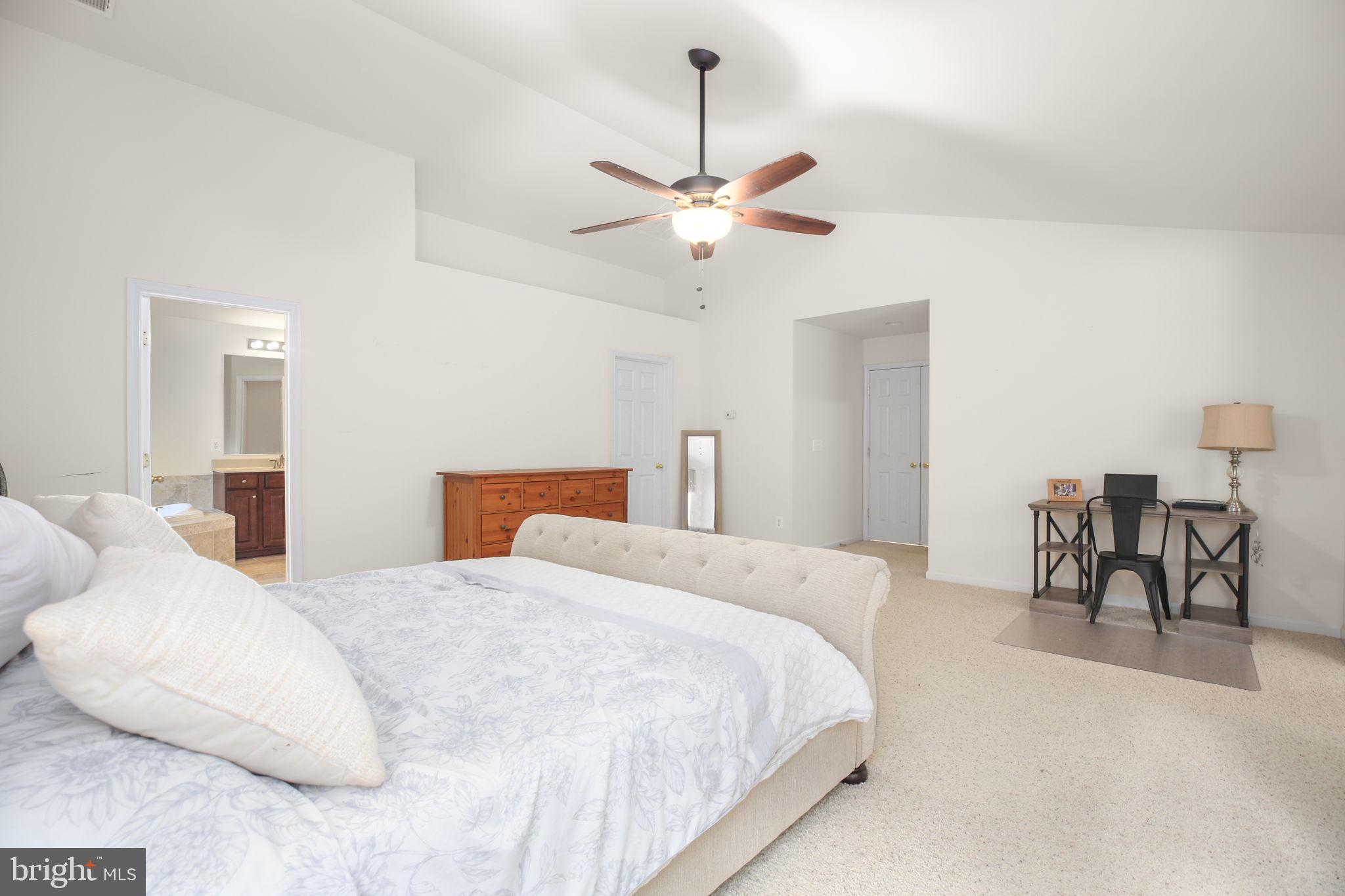 10108 Willow Ridge Lane Spotsylvania, VA 22553 - Photo 46 of 61 a bedroom with a bed chandelier and a window