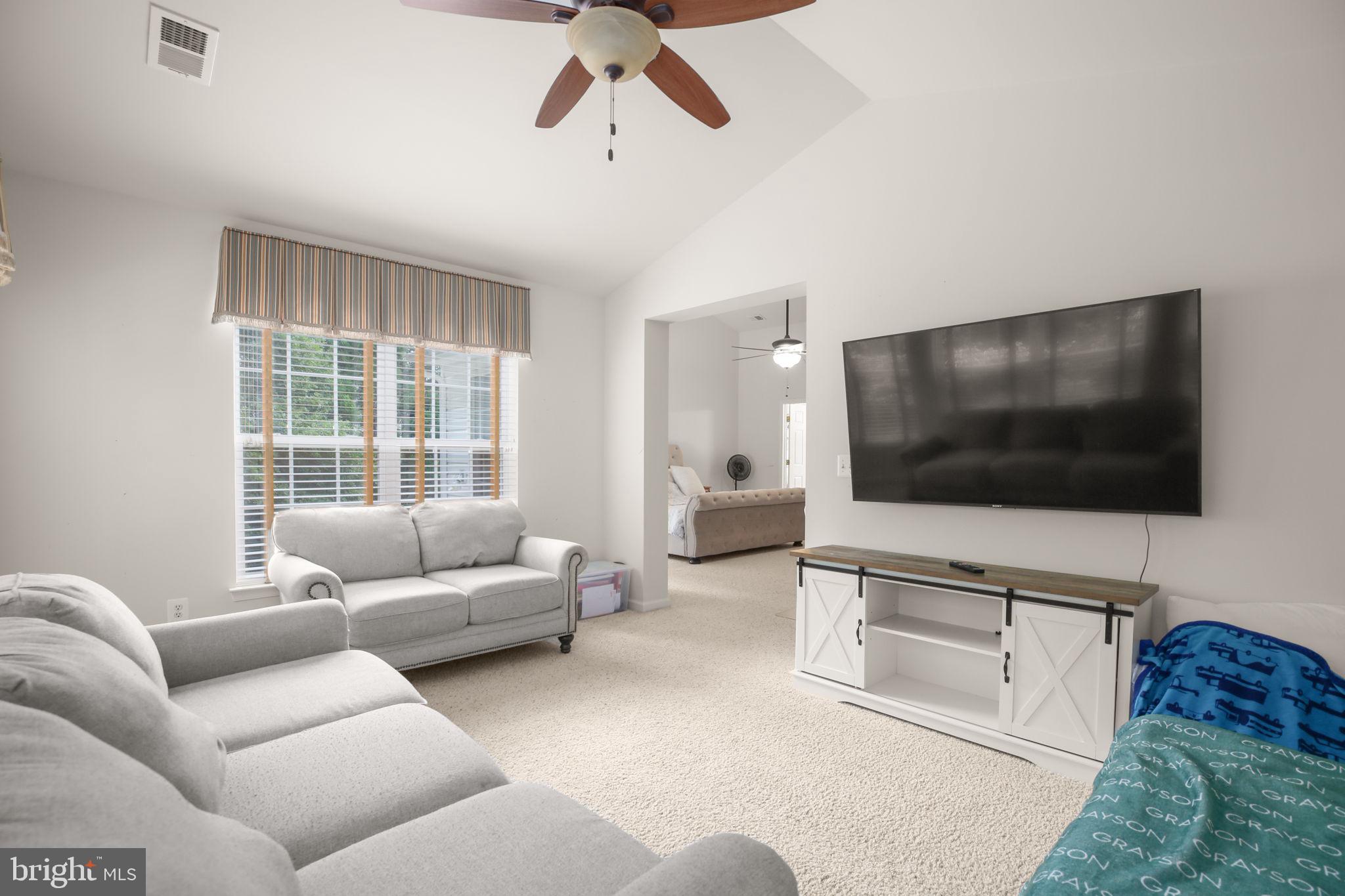 10108 Willow Ridge Lane Spotsylvania, VA 22553 - Photo 47 of 61 a living room with furniture and a flat screen tv