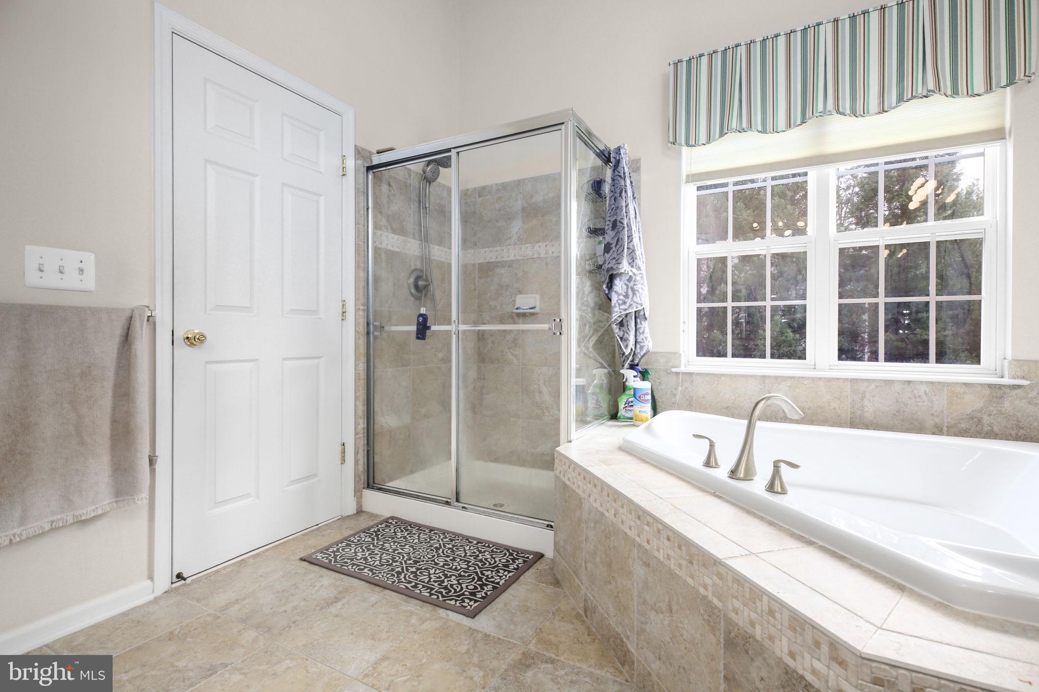 10108 Willow Ridge Lane Spotsylvania, VA 22553 - Photo 49 of 61 a bathroom with a bathtub and a shower