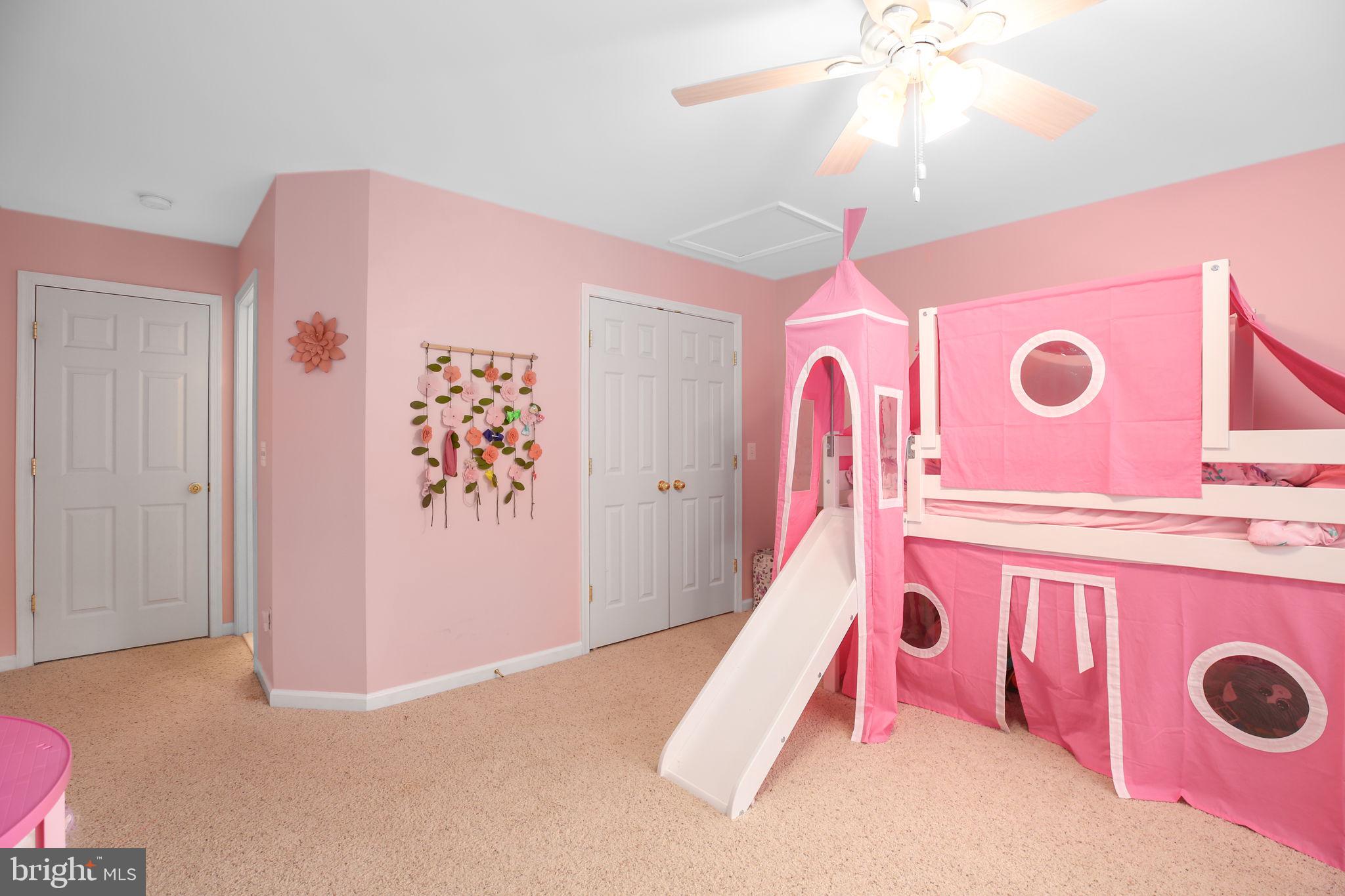 10108 Willow Ridge Lane Spotsylvania, VA 22553 - Photo 53 of 61 a spacious bedroom with a bed and a chandelier