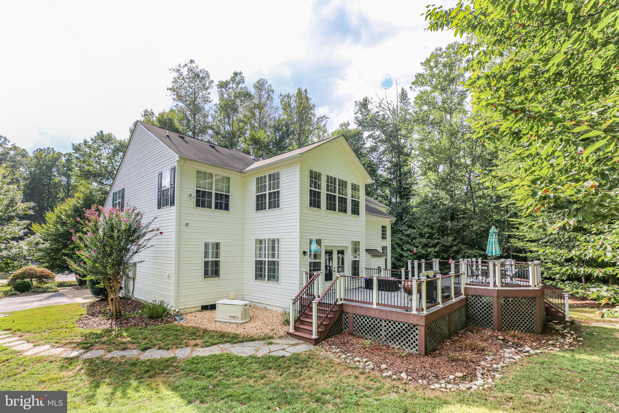 10108 Willow Ridge Lane Spotsylvania, VA 22553 - Photo 9 of 61 a view of a house with backyard sitting area and garden