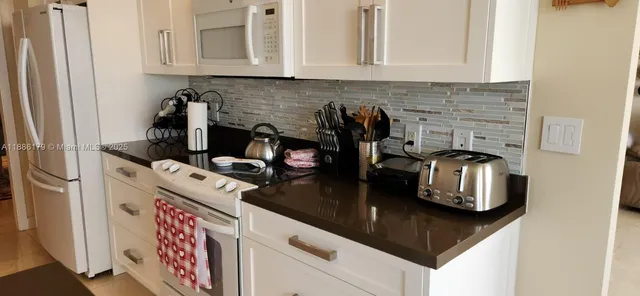 a kitchen with sink and cabinets