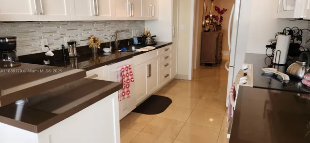 a kitchen with granite countertop a stove and a refrigerator
