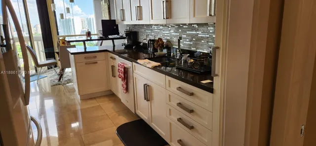 a kitchen with refrigerator and cabinets