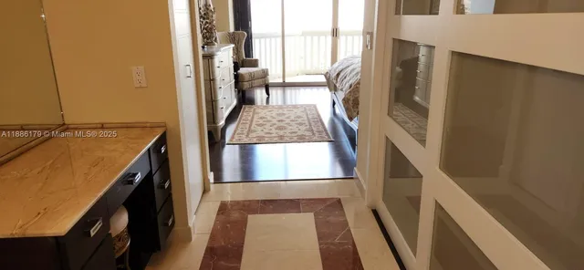 a view of a kitchen from a corridor