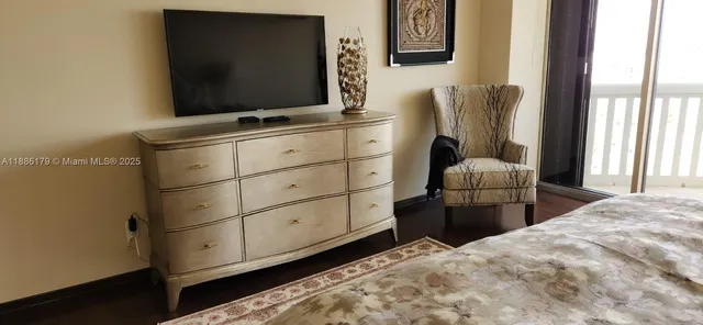 a bedroom with a bed and flat screen tv